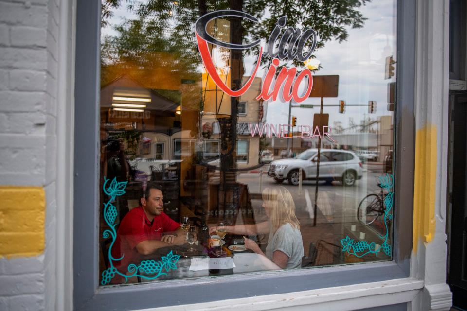 Travis and Danielle Guerette of Severance enjoy a light meal and a glass of wine in 2021 at Ciao Vino Wine Bar in Old Town Fort Collins.