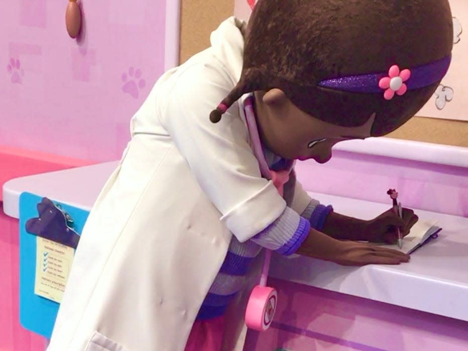 doc mcstuffins signing an autograph book at a meet and greet in disney world