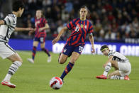 United States forward Carli Lloyd (10) chases the a pass between two South Korea players in the first half of a soccer friendly match, Tuesday, Oct. 26, 2021, in St. Paul, Minn. (AP Photo/Andy Clayton-King)