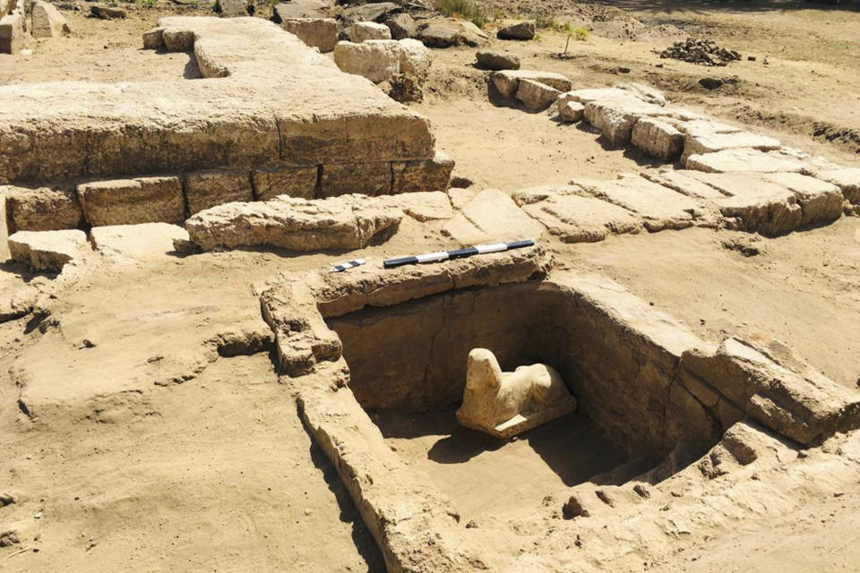 In this undated photo distributed Monday, March 6, 2023, by the Egyptian Ministry of Tourism and Antiquities, a sphinx statue believed to be made in the likeness of a Roman emperor is uncovered from an archaeological site in Qena, Egypt. The site that also contains a shrine to the Ancient Egyptian god Horus dating back to the Roman era, according to the country’s top antiquities official Mostafa Waziri. Waziri also said in a statement that initial examinations point to the statue being modeled after the Roman Emperor Claudius, who ruled in the first century AD. (Egyptian Ministry of Tourism and Antiquities via AP)