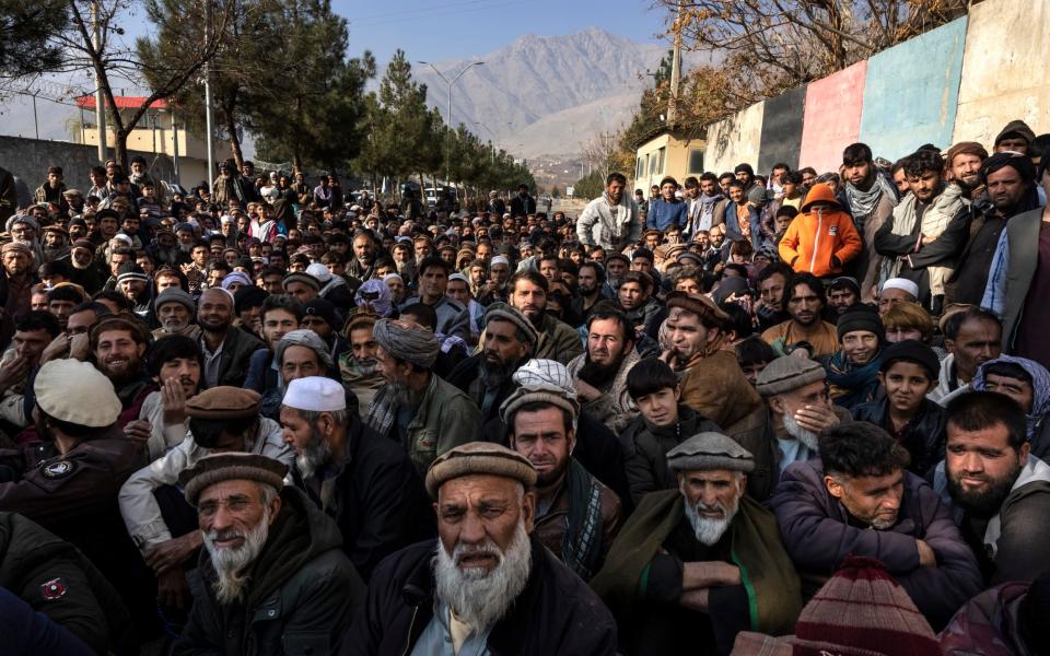 Hundreds of people waiting for humanitarian aid in the village of Charikar - Paula Bronstein/Telegraph