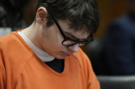 Ethan Crumbley sits in court listening to victim impact statements, Friday, Dec. 8, 2023, in Pontiac, Mich. Parents of students killed at Michigan's Oxford High School described the anguish of losing their children Friday as a judge considered whether a teenager will serve a life sentence for a mass shooting in 2021. Crumbley, 17, could be locked up with no chance for parole for killing four fellow students and wounding others. (AP Photo/Carlos Osorio, Pool)