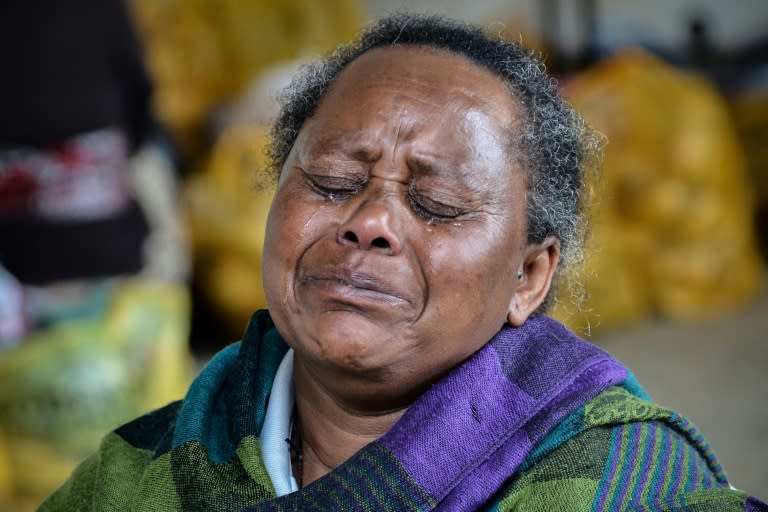 Askale Adacha, 63, weeps as she speaks about fleeing the violence on the outskirts of the Ethiopian capital