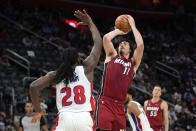 Miami Heat guard Jaime Jaquez Jr. (11) shoots on Detroit Pistons center Isaiah Stewart (28) in the second half of an NBA basketball game in Detroit, Sunday, March 17, 2024. (AP Photo/Paul Sancya)