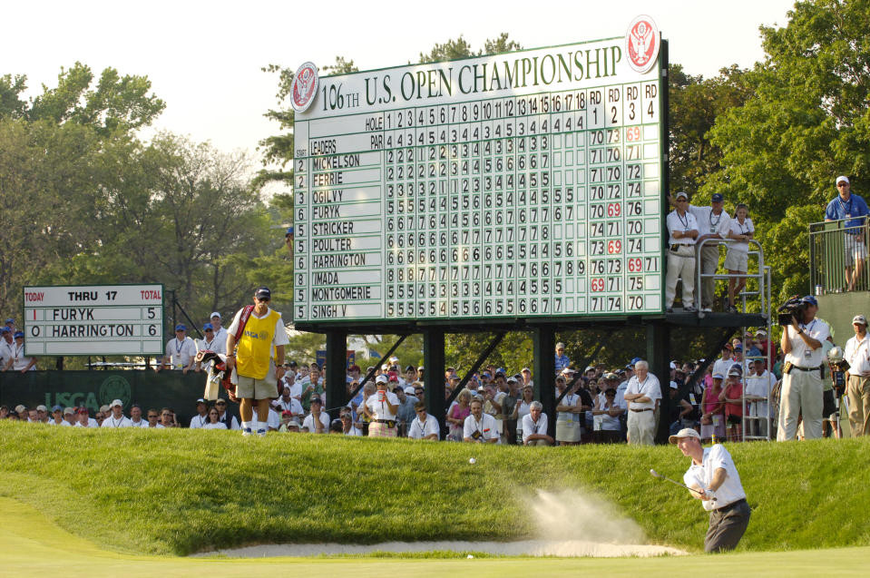 The leaderboard shows the scores as Jim Furyk of the United States hits out of a bunker on the 18th hole during the final round of the 2006 U.S. Open Championship at Winged Foot Golf Club.  (Photo by Howard Earl Simmons/NY Daily News Archive via Getty Images)