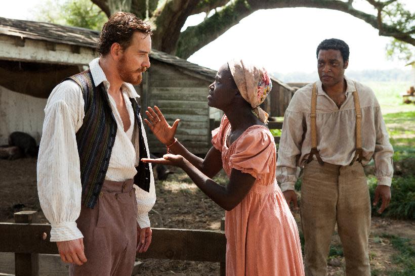 This image released by Fox Searchlight shows Michael Fassbender, left, Lupita Nyong'o and Chiwetel Ejiofor, right, in a scene from the film, "12 Years A Slave." The film has nine Academy Awards nominations, including Nyong'o nominated for her performance by an actress in a supporting role. (AP Photo/Fox Searchlight, Francois Duhamel, file)