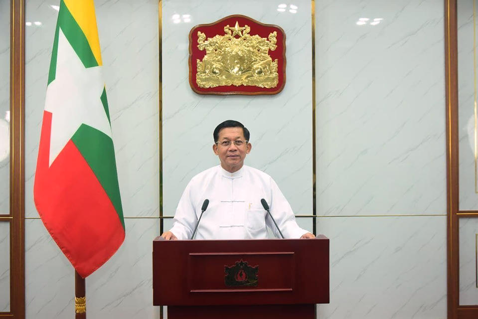 In this image provided by Myanmar state broadcaster MRTV, Senior General Min Aung Hlaing, chairman of the State Administration Council, gives a televised address on Tuesday, Feb. 1, 2022, in Naypyitaw, Myanmar. Opponents of military rule in Myanmar on Tuesday marked the one-year anniversary of the army's seizure of power with a nationwide strike to show their strength and solidarity amid concern about what has become an increasingly violent contention for power. (MRTV via AP)