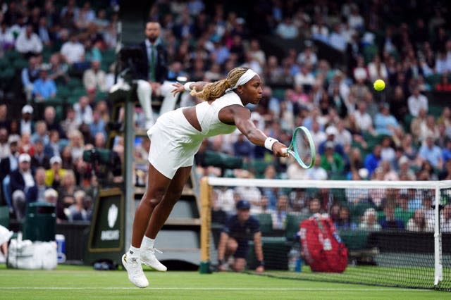 Coco Gauff stretches to hit a volley