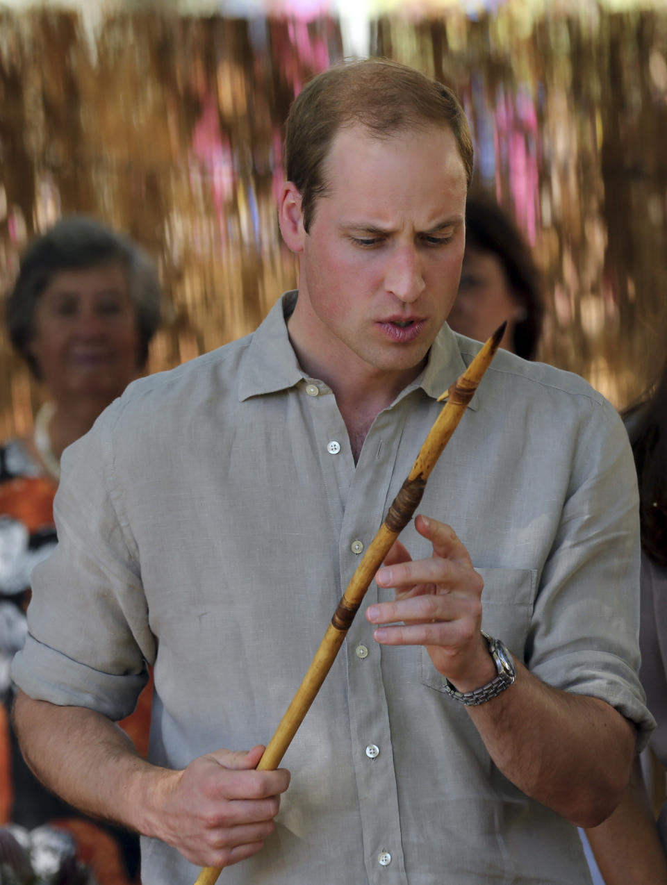 Britain's Prince William looks at a ceremonial spear given to him after he arrived at the National Indigenous Training Academy at Yulara, near Uluru, Australia, Tuesday, April 22, 2014. (AP Photo/Rob Griffith)