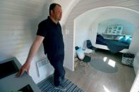 Iglucraft company CEO Kallas shows a Igluhut cabin in Leie