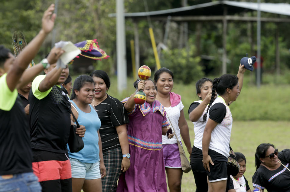 In this Nov. 25, 2018 photo, Ngabe-Bugle indigenous women support their women's soccer team during the second edition of the Panamanian indigenous games in Piriati, Panama. Ngabe-Bugle is the largest and most populous of Panama's three Indigenous regions. (AP Photo/Arnulfo Franco)