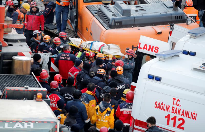 Rescue workers carry the body of an earthquake victim in Elazig