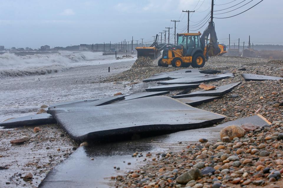 The remnants of East Beach Road in Westport are seen in the foreground after heavy overnight winds and surf battered the coastline.