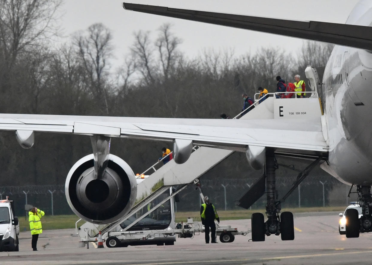 Passengers disembark from the plane carrying British nationals from the coronavirus-hit city of Wuhan in China, arrives at RAF Brize Norton in Oxfordshire.