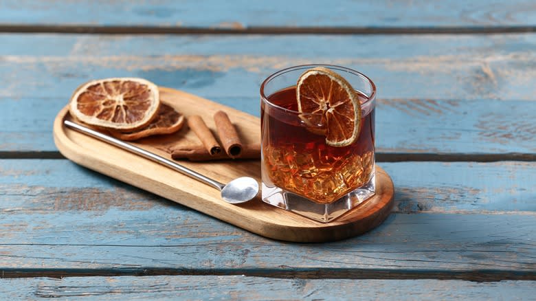 Cinnamon-infused cocktail with dried orange wheel