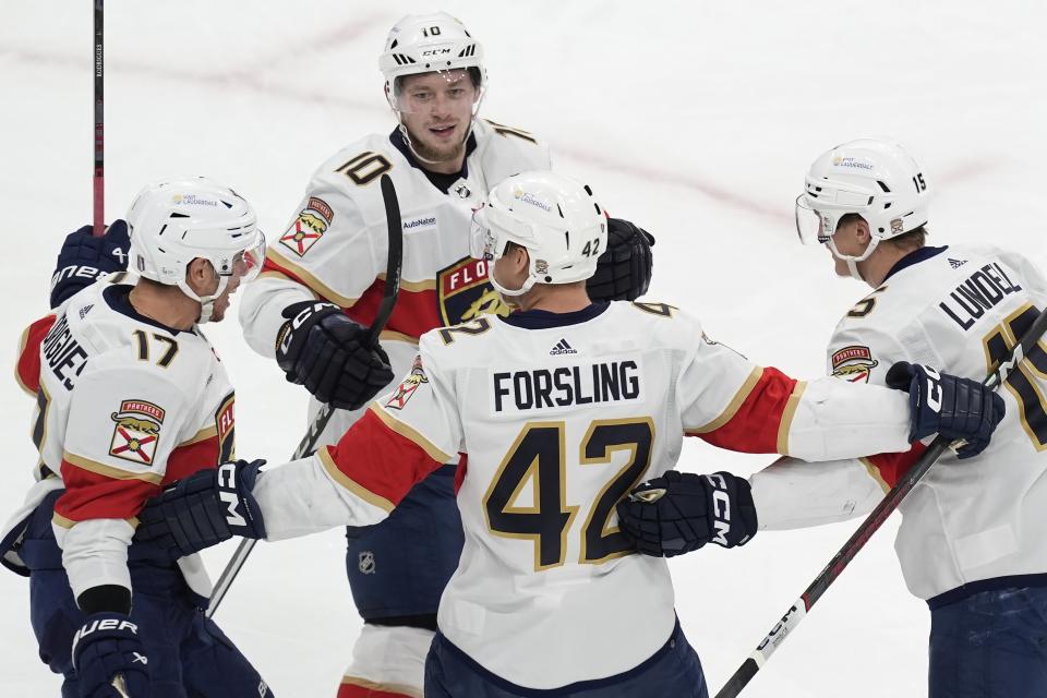 Florida Panthers' Evan Rodrigues (17) celebrates his goal against the Boston Bruins with Gustav Forsling (42), Anton Lundell (15) and Vladimir Tarasenko (10) during the first period in Game 3 of an NHL hockey Stanley Cup second-round playoff series Friday, May 10, 2024, in Boston. (AP Photo/Michael Dwyer)