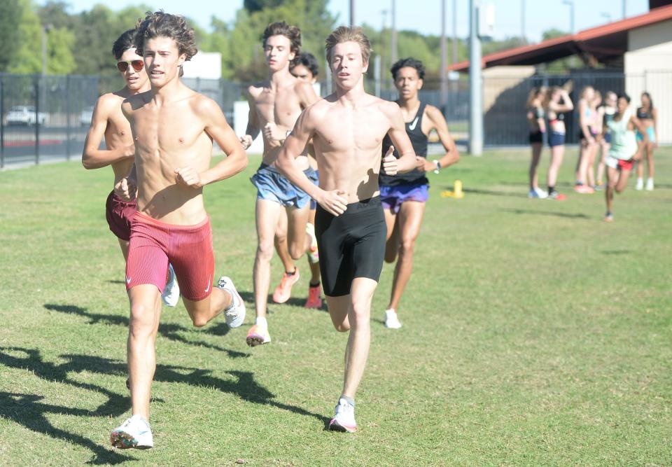 Newbury Park's Lex Young, left, and Aaron Sahlman, right, lead the pack during a training session at Conejo Creek South in Thousand Oaks on Tuesday, Nov. 23, 2021.