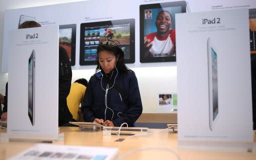 A customer is seen looking at an iPad 2 at an Apple Store in San Francisco, California. Eleven percent of US adults now own a tablet computer such as Apple's iPad or some other device, according to a recent study