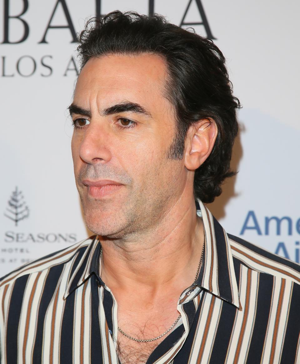 Sacha Baron Cohen wearing a striped shirt at an event