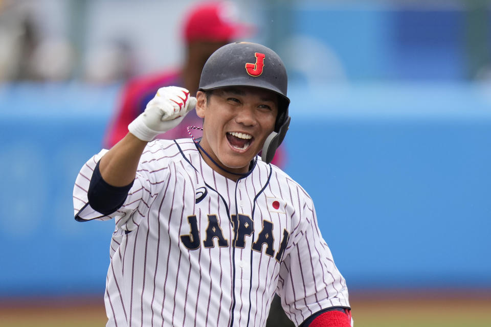 Japan's Hayato Sakamoto celebrates his walk-off single in the ninth inning of a baseball game against the Dominican Republic at the 2020 Summer Olympics, Wednesday, July 28, 2021, in Fukushima, Japan. Japan won 4-3. (AP Photo/Jae C. Hong)