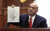 State Police Trooper Joseph Silva Jr. shows the hand print impression he took of former New England Patriots NFL football player Aaron Hernandez during the Hernandez murder trial in Fall River, Massachusetts February 26, 2015. Hernandez is charged in the murder of Odin Lloyd in 2013. REUTERS/Charles Krupa/Pool (UNITED STATES - Tags: SPORT FOOTBALL CRIME LAW)