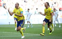 <p>Paying the penalty: Andreas Granqvist wheels away after slotting home his side’s first goal of the World Cup. (Reuters) </p>