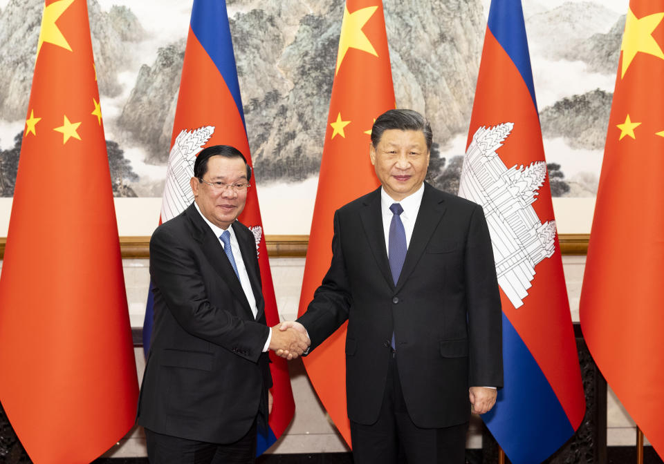 In this photo released by China's Xinhua News Agency, Cambodia's Prime Minister Hun Sen, left, and Chinese President Xi Jinping shake hands on the sidelines of a meeting at the Diaoyutai State Guesthouse in Beijing, Friday, Feb. 10, 2023. Hun Sen met Friday with Xi Jinping on a visit to his ally that underscores increasingly close ties between the two Asian countries. (Huang Jingwen/Xinhua via AP)