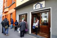 An old man in need leaves the soup kitchen "Kana" with food supplies from a food bank in a poor district of the city of Dortmund, western Germany, April 7, 2017. Picture taken April 7, 2017. REUTERS/Wolfgang Rattay