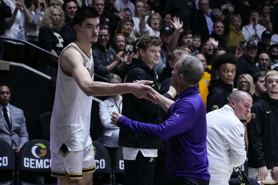 Northwestern Wildcats head coach Chris Collins shakes hands with Purdue center Zach Edey (15) as he leaves the court after a technical foul during the second half of an NCAA college basketball game in West Lafayette, Ind., Wednesday, Jan. 31, 2024. Purdue defeated against the Northwestern Wildcats 105-96 in overtime. (AP Photo/Michael Conroy)