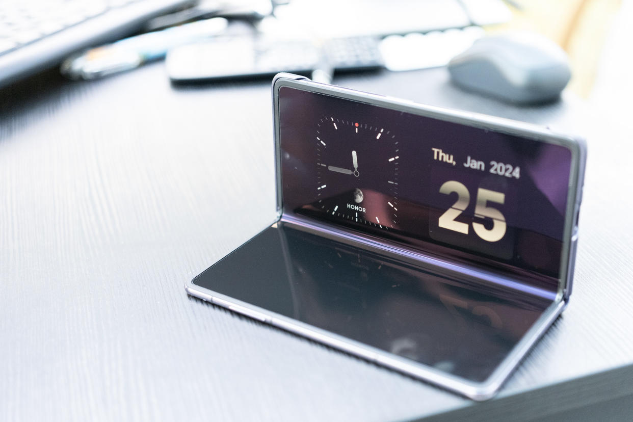  An Honor Magic V2 foldable phone sitting on a desk. 