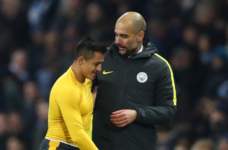 Alexis Sanchez and Pep Guardiola embrace after the final whistle of a match between Manchester City and Arsenal in 2016. (Getty Images)