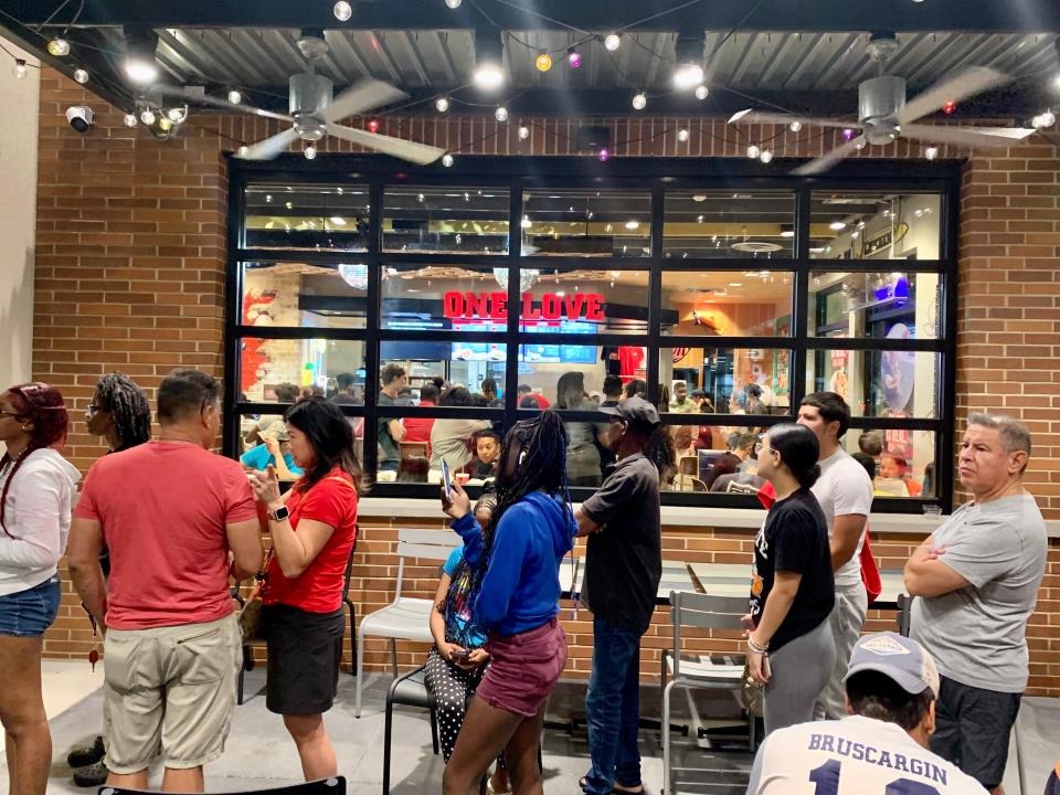 Customers wait in line at the grand opening of Raising Cane's in Boynton Beach.