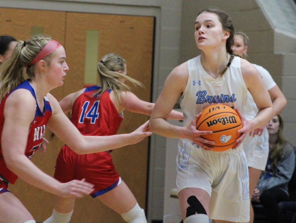 Bartlesville High senior center Ragen Hodge, right, keeps a firm grip on the basketball during Tuesday's showdown against Bixby High at the Bruin Fieldhouse.