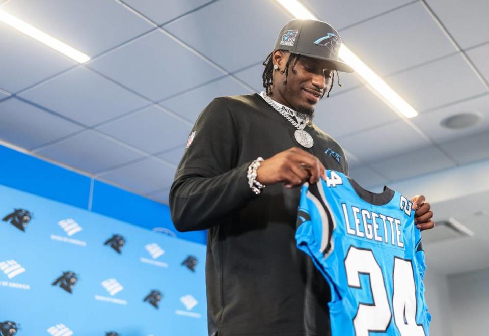 Carolina Panthers draft pick Xavier Legette holds a jersey at the Bank of America Stadium in Charlotte, N.C., on Friday, April 26, 2024.