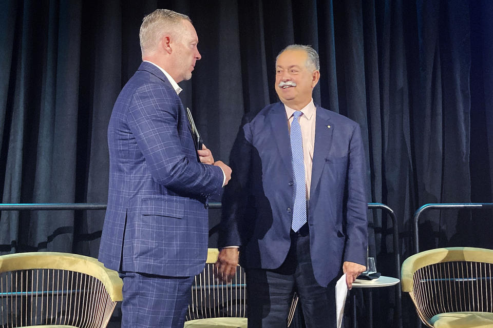 Andrew Liveris, right, president of the Brisbane Olympics organizing committee and Jock O'Callaghan, president of Paralympics stand on the stage at the general assembly of the Oceania National Olympic Committees in Brisbane, Australia, on Tuesday, April 18, 2023. In the 12 months since his appointment as inaugural president of the organizing committee for the Brisbane 2032 Olympics, Liveris has refined his vision of what the Summer Games will look like in nine years. (AP Photo/John Pye)