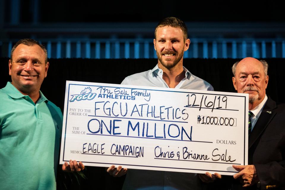 Chris Sale of the Boston Red Sox holds a $1 million check during Night at the Nest Gala on Friday, December 6, 2019, at Alice Arena in Florida Gulf Coast University.