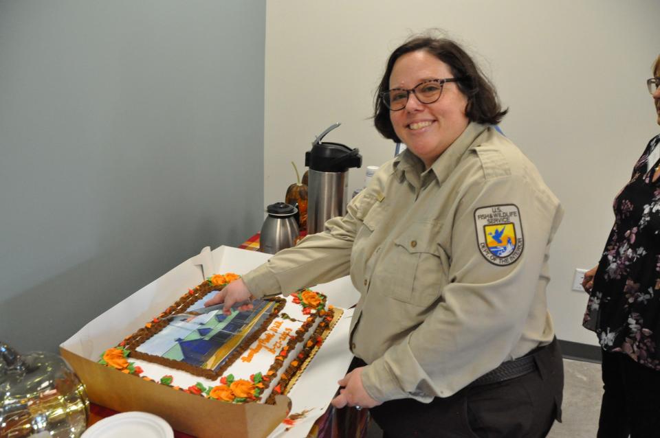 Cutting the cake after the ribbon-cutting ceremony Friday, Oct. 27, 2023 at the new Bombay Hook Wildlife Refuge visitors center is Kate Toniolo, project leader of the Coastal Delaware National Wildlife Refuge Complex which includes Bombay Hook and Prime Hook.