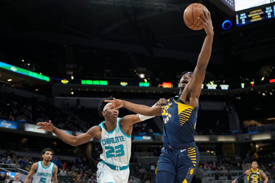 Indiana Pacers guard Terry Taylor (32) fights for a rebound with Charlotte Hornets forward Kai Jones (23) during the second half of an NBA basketball game in Indianapolis, Wednesday, Jan. 26, 2022. The Hornets won 158-126. (AP Photo/AJ Mast)