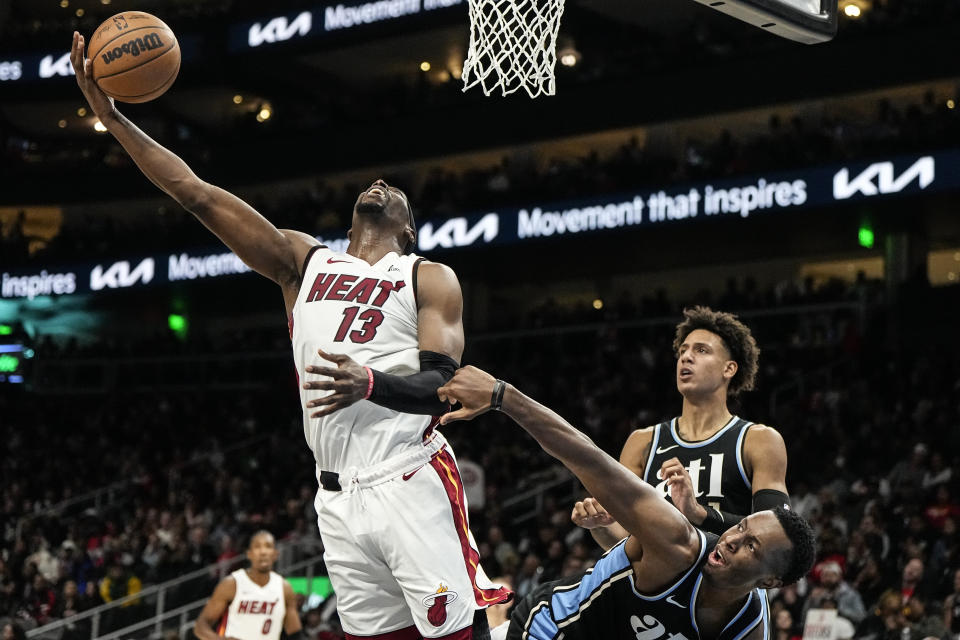 Miami Heat center Bam Adebayo (13) shoots against Atlanta Hawks forward Onyeka Okongwu (17) during the second half of an NBA basketball game, Saturday, Nov. 11, 2023, in Atlanta. The Miami Heat won 117-109. (AP Photo/Mike Stewart)