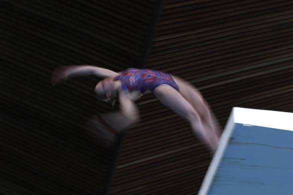 A member of Crystal Palace diving club dives during a training session in London March 9, 2012.