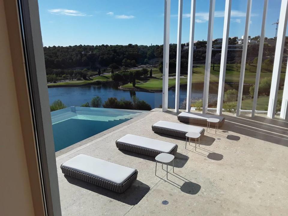 Vista desde interior de la villa a la piscina y al campo de golf