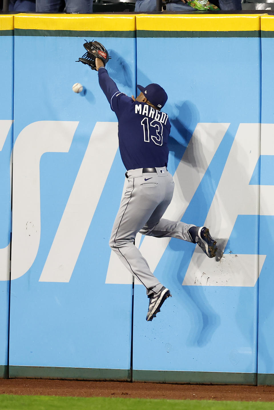 Tampa Bay Rays right fielder Manuel Margot cannot make a leaping catch on a one-run triple by Cleveland Guardians' Jose Ramirez during the third inning of a baseball game, Tuesday, Sept. 27, 2022, in Cleveland. (AP Photo/Ron Schwane)