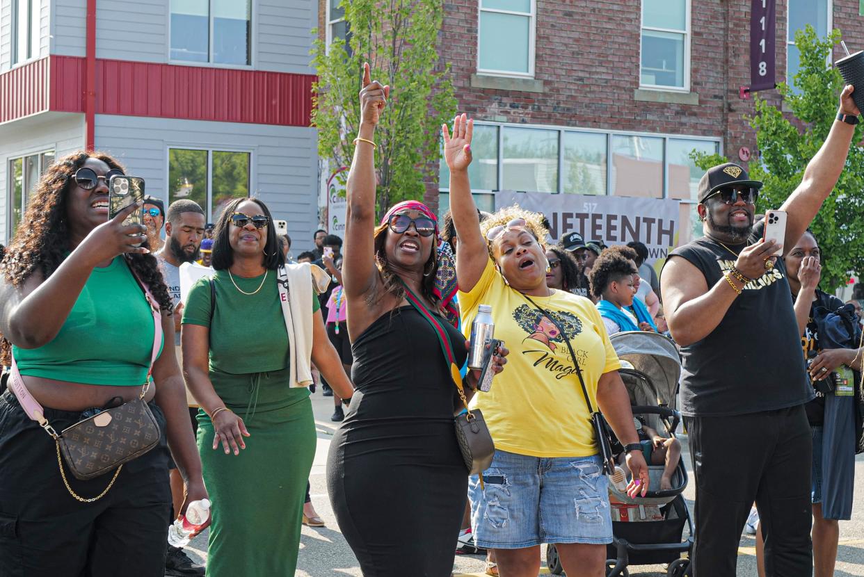 The audience responds to The Singletons praise music at the Juneteenth celebration in Lansing's REO Town Saturday, June 17, 2023.