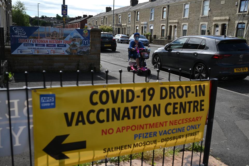 A pedestrian walks past a Covid-19 vaccination centre set up at the Masjid e Saliheen mosque in Blackburn, north west England on June 16, 2021. (Oli Scarff/AFP via Getty Images)