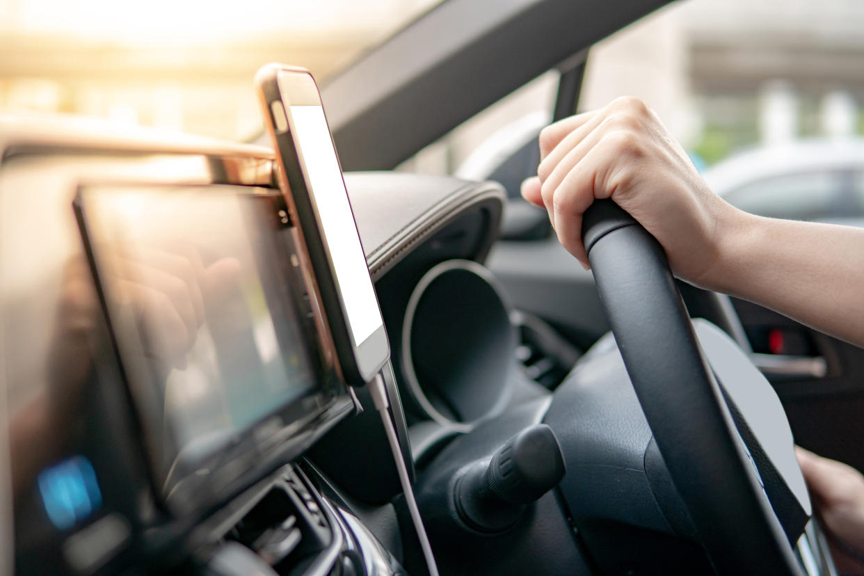 MPs have warned that a ban on driving with hands-free phones "should be considered" (Picture: Getty)