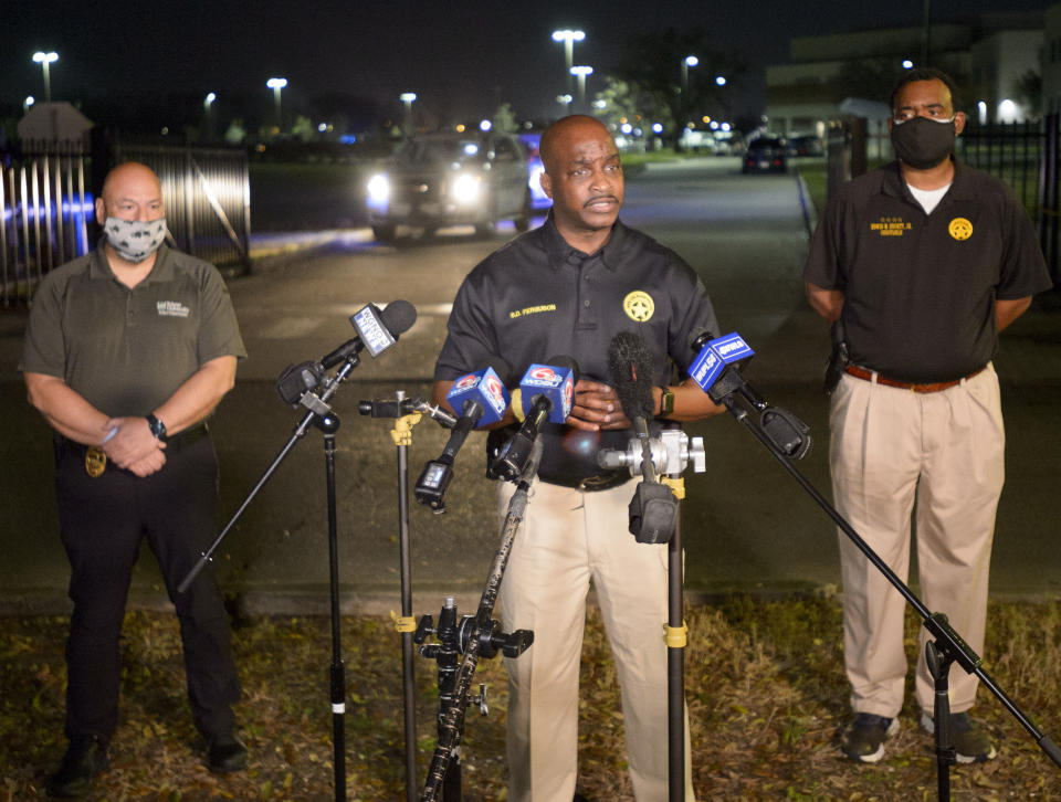 New Orleans Police Chief Shaun Ferguson, center, updates the media on the investigation of a shooting at George Washington Carver High School where a law enforcement officer was fatally shot as a basketball game was being played in New Orleans, Friday, Feb. 26, 2021. (Max Becherer/The Times-Picayune/The New Orleans Advocate via AP)
