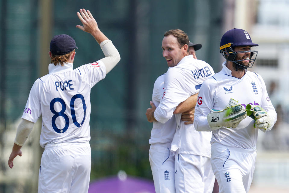 England's Tom Hartley, right and Ollie Pope, left celebrate the wicket of India's captain Rohit Sharma on the fourth day of the fourth cricket test match between England and India in Ranchi, India, Monday, Feb. 26, 2024. (AP Photo/Ajit Solanki)