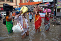 <p>Indian floods wreak havoc</p><p>Indian devotees carry their luggage and wade through the flooded water in Varanasi, India, Friday, Aug. 26, 2016. (AP Photo/Tsering Topgyal)</p>