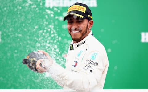 Race winner Lewis Hamilton of Great Britain and Mercedes GP celebrates on the podium during the Formula One Grand Prix of Brazil at Autodromo Jose Carlos Pace on November 11, 2018 in Sao Paulo, Brazil.  - Credit: Getty Images