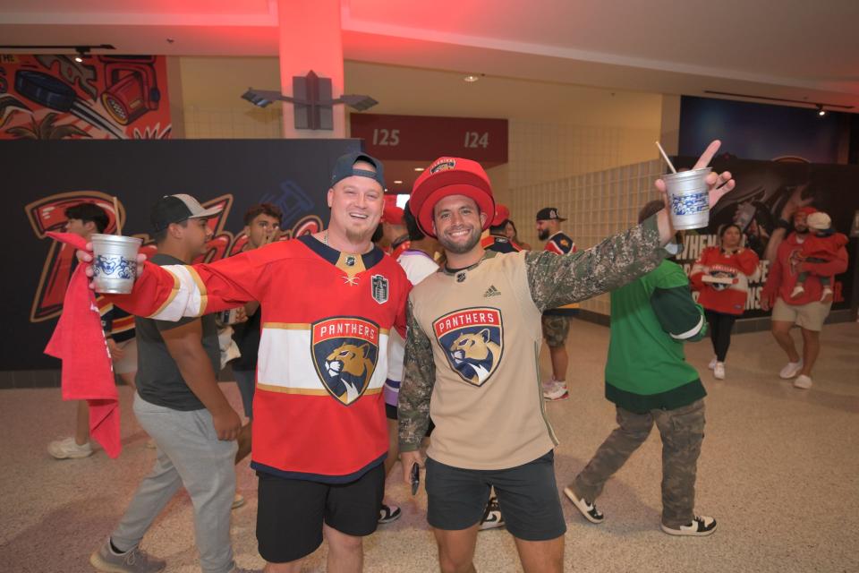 Panthers fans Ryan Mariano and Michael Milam pose in the plaza at Amerant Bank Arena while watching the Panthers play Edmonton in a Game 6 watch party (June 21, 2024).